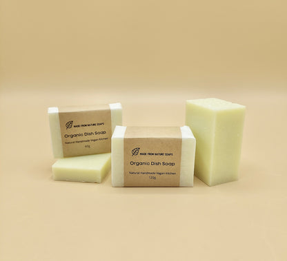 Bars of organic dish soap on a beige background Made with plant-based ingredients (such as coconut oil), they are free from harsh synthetic additives, parabens, and phosphates, making them gentle on hands and ideal for sensitive skin.
