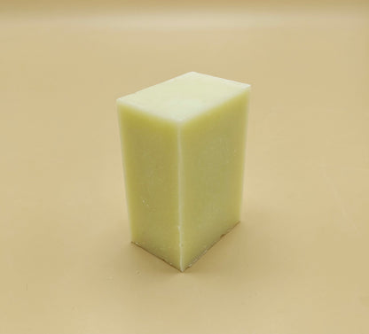 White rectangular bar of soap on a beige background. Organic kitchen dish soap bars offer a sustainable, non-toxic, and cost-effective alternative to liquid detergent.